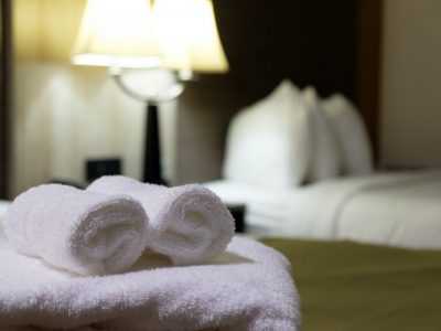 White bath towel on bed in hotel room
